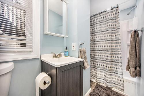 a bathroom with a sink and a shower at The Downtown Delight - New Corporate Apt Downtown in Grand Rapids