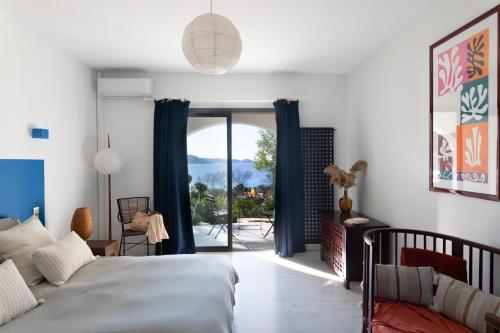 a bedroom with a bed and a sliding glass door at Waterfront property, pool, jacuzzi in Pietrosella