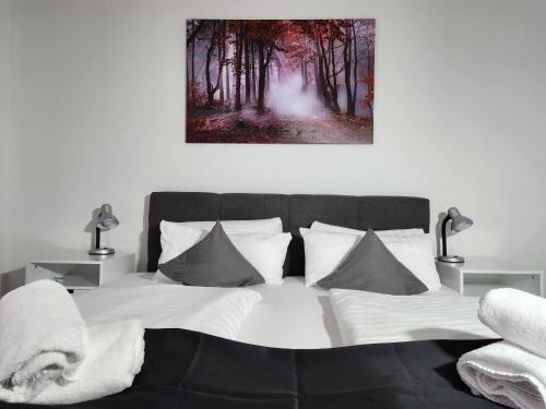 a bed with white sheets and pillows in a bedroom at HOTEL Schiff in Rastatt