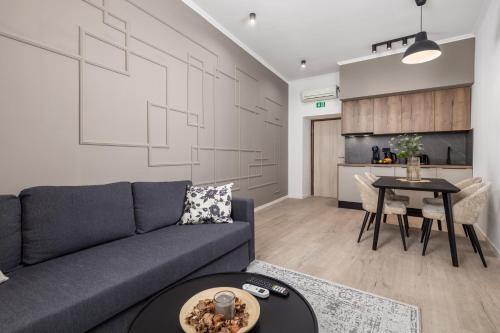 a living room with a couch and a table at Molo Longo - Downtown Apartments in Rijeka