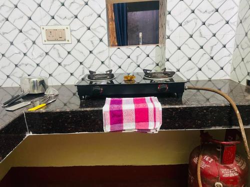 a counter top with a pink and white towel on it at AV Homestay in Varanasi
