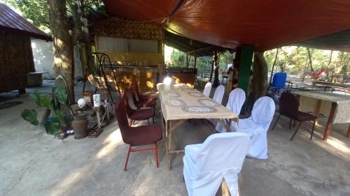 a long table and chairs in a tent at Secluded Glamping Yoga Samadhi Resort 