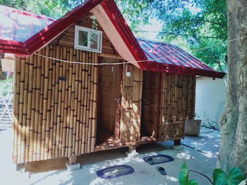 a wooden dog house with a red roof at Secluded Glamping Yoga Samadhi Resort 