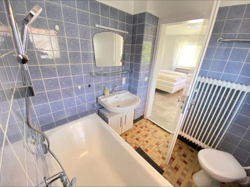 a bathroom with a tub and a toilet and a sink at Haus Schwarzwald in Bad Krozingen in Bad Krozingen
