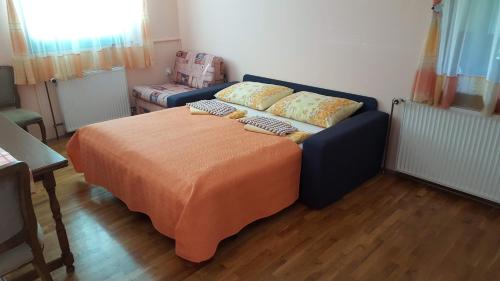 a bed with two pillows on it in a room at Guesthouse Pavličić in Drežnik Grad