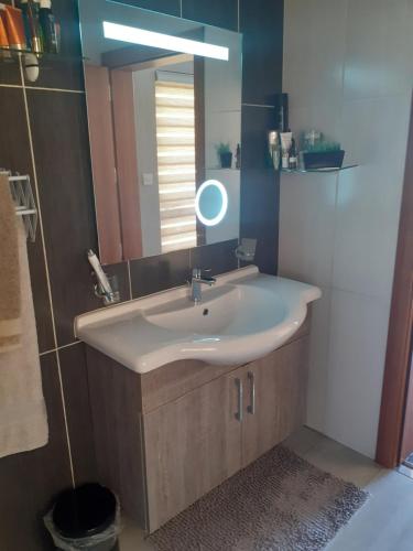 a bathroom with a sink and a mirror at Cosy Home by the Sea in Birżebbuġa