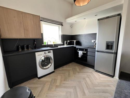 a kitchen with a washer and a washing machine in it at Luxury home in rugby ready 4U 
