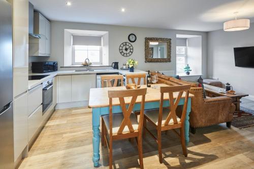 a kitchen and dining room with a table and chairs at Host & Stay - Fenwick Village Hall in Fenwick