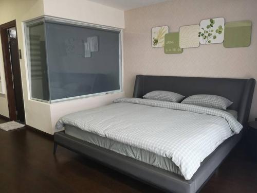 a bedroom with a bed with a large window at Summer Escapes in Johor Bahru