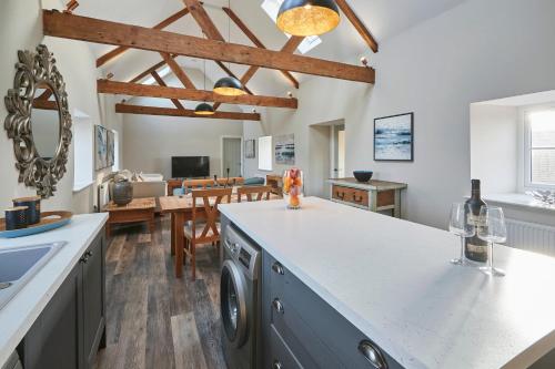 a kitchen with a washer and dryer on a counter at Host & Stay - Fenwick Village Hall in Fenwick