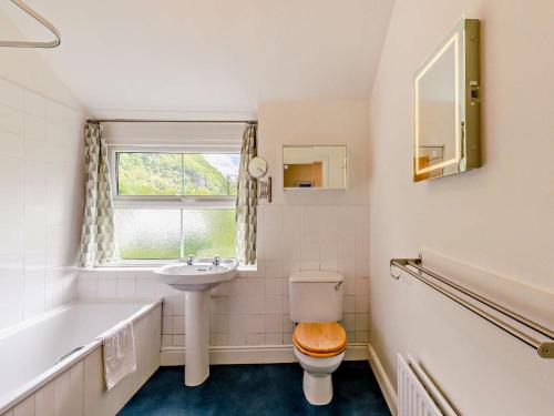a bathroom with a toilet and a sink and a tub at 3 Bed in Borrowdale SZ148 in Grange