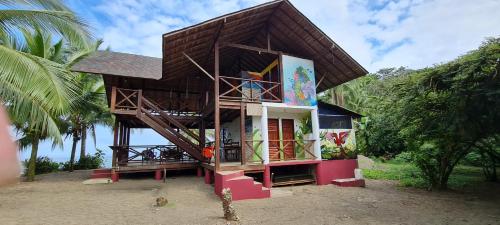 a small house with a gambrel roof at La Joviseña in Nuquí
