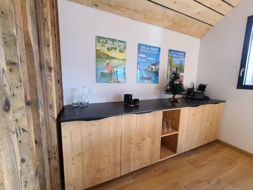 a bar in a room with a wooden wall at L'Alpage, vue lac in Brison-Saint-Innocent