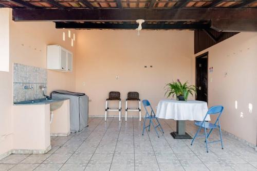 a kitchen with a table and chairs in a room at Suite Vista Panorâmica in Betim