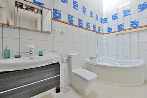 a white bathroom with a toilet and a sink at 5,Batthyani Square, Buda, Panorama, Parliament in Budapest