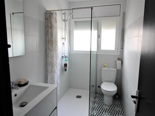 a bathroom with a toilet and a glass shower at Apartamento Roses, 2 dormitorios, 6 personas - ES-258-76 in Roses