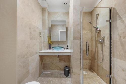 a bathroom with a shower and a sink at Pristine Stylish Townhouse on the Stray - Sleeps 8 in Harrogate