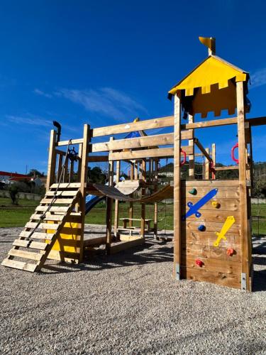 a playground with a wooden play structure with a slide at Casa Martins Country Apt, No.6 in Freiria