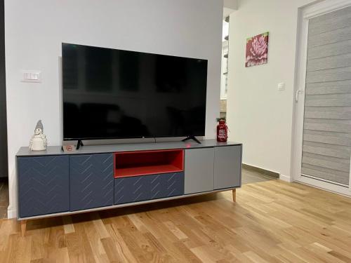 a flat screen tv sitting on a entertainment center in a living room at Short stay accommodation in Dolno Nerezi