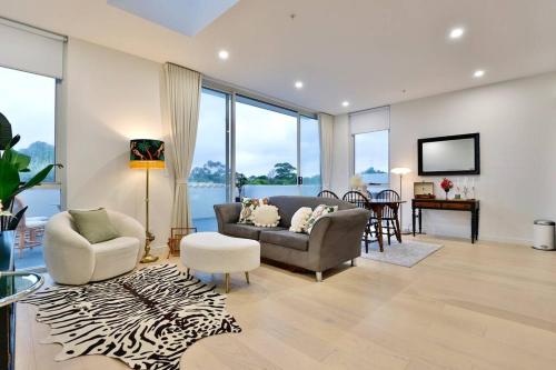 a living room with a couch and chairs and a table at Lumière Sanctuary - Antique Elegance with Parking in Sydney