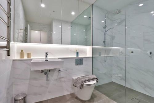 a bathroom with a toilet and a sink and a shower at Lumière Sanctuary - Antique Elegance with Parking in Sydney
