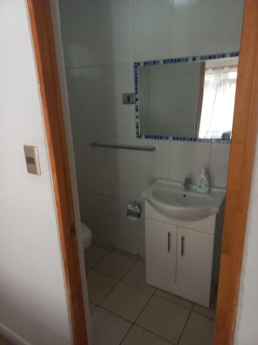 a bathroom with a sink and a mirror at Rutero in La Serena