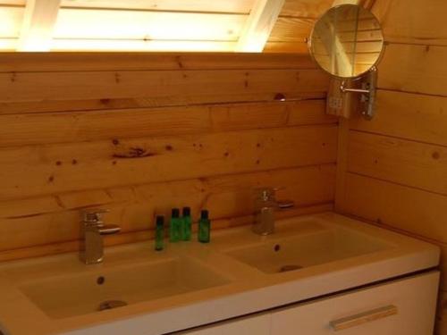 a bathroom with a sink with a mirror and a mirror at Romantic Rural Retreats in Crewkerne