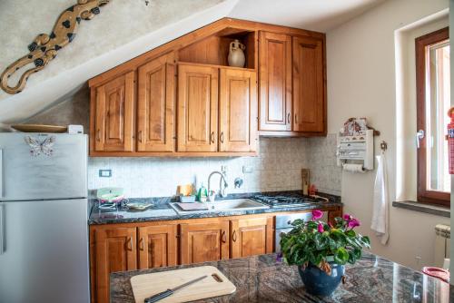 a kitchen with wooden cabinets and a sink at Via della musica in Vicchio