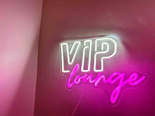 a neon sign that says vip lounge on a wall at Cool 2 Bed Hornchurch House, Arcade Games, Free Parking in Hornchurch