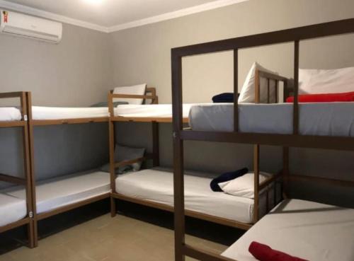 a room with three bunk beds in a room at Caucaia Cit in Caucaia