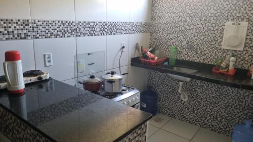 a kitchen with a stove and a counter top at Caucaia Cit in Caucaia
