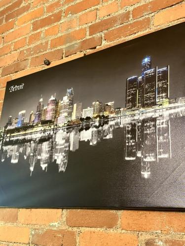 a painting of a city skyline on a brick wall at Queen G Investments apts in Detroit
