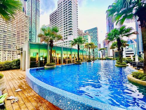 a large swimming pool in a city with tall buildings at VortexLuxApartman KLCC, kuala lampur city in Kuala Lumpur