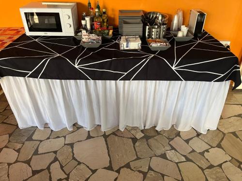 a black and white table with a microwave on it at Hotel Wega in Bellaria-Igea Marina