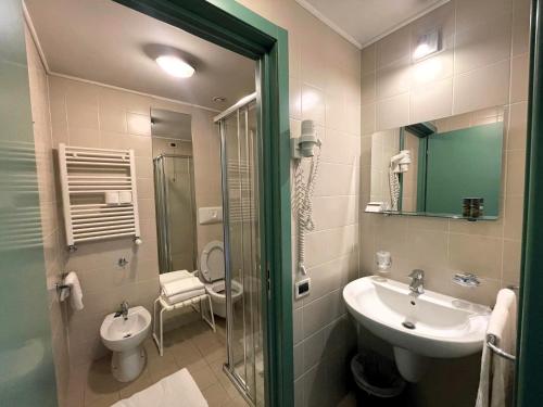 a bathroom with a sink and a toilet at Attico Villaggio Olimpico Sestriere in Sestriere