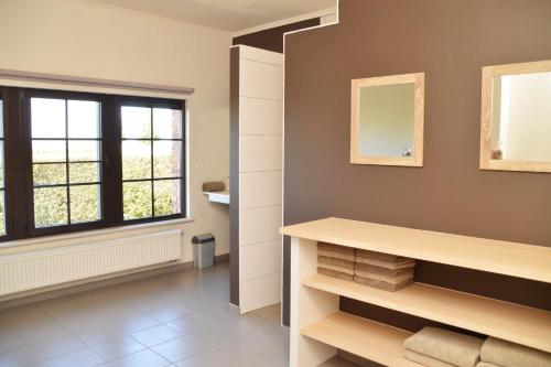 a bathroom with a shelf and a window at Rozenberghoeve 