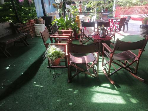 a group of chairs and tables with plants on a patio at Casa campestre Rancho San Juan in El Pantano