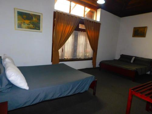 a hotel room with a bed and a window at Spring Shannon Heritage in Diyatalawa