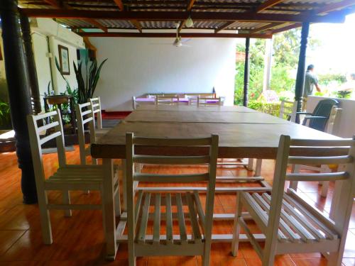 a large wooden table and chairs in a room at Spring Shannon Heritage in Diyatalawa
