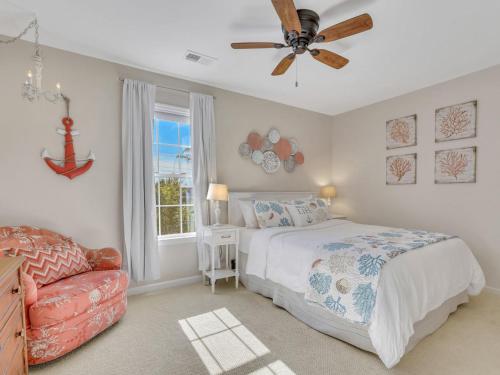 a bedroom with a bed and a ceiling fan at Peaceful Beach Vacation, Heated Pool Access, Walk to Restaurants & More! in Tybee Island