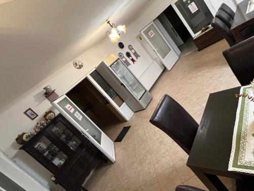 an overhead view of a kitchen with a table and refrigerator at Pensiunea Sandra in Ocna Şugatag