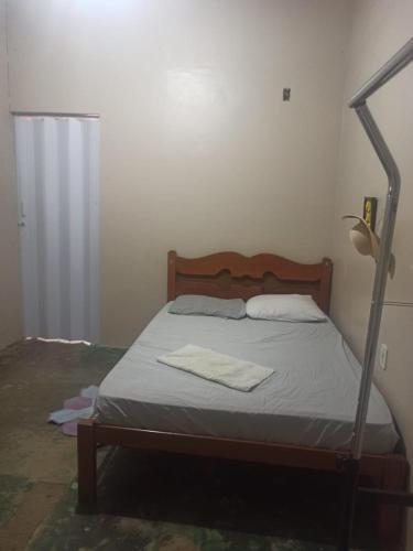 a bedroom with a bed with a metal bed frame at A silenciosa in Brasília