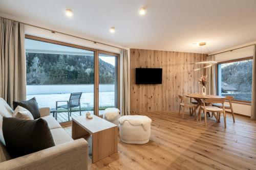 a living room with a couch and a table at Chalet Samont in Laion