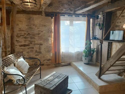 a living room with a chair and a window at Le Pigeonnier in Martel