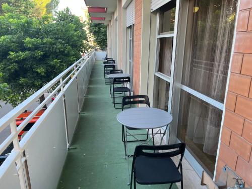 a row of tables and chairs on a balcony at Hotel Wega in Bellaria-Igea Marina