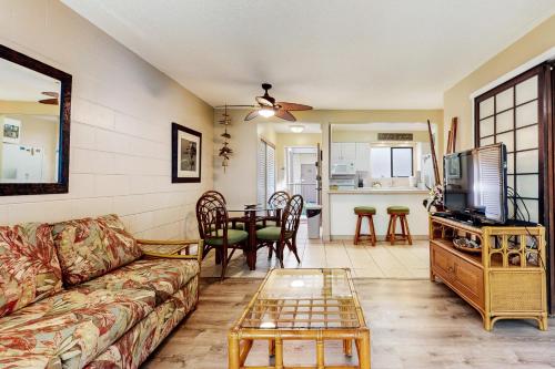 a living room with a couch and a table at Hono Kai B17 in Wailuku