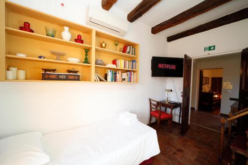 a bedroom with a white bed and a desk at BolognaRoomscom - Ca' Palazzo in Sasso Marconi
