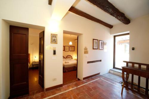 a hallway with a room with a bed and a window at BolognaRoomscom - Ca' Palazzo in Sasso Marconi