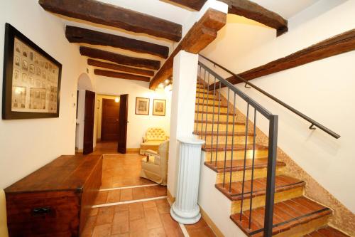 a staircase in a home with wooden floors and beams at BolognaRoomscom - Ca' Palazzo in Sasso Marconi