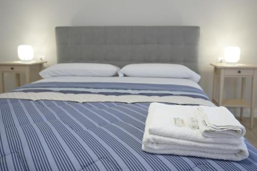 - une chambre avec un lit et des serviettes dans l'établissement B&B DE MICHELE, à Santa Maria Capua Vetere